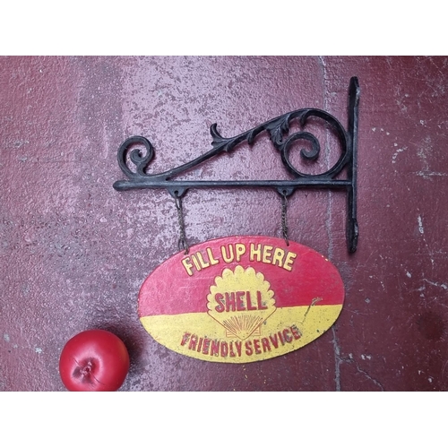 409 - Vintage Shell Friendly Service sign with wrought iron bracket, featuring the iconic red and yellow S... 