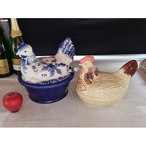 434 - Two ceramic hen-shaped lidded dishes; one with blue floral patterns, the other cream-colored with br... 