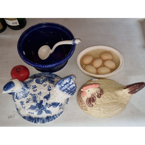 434 - Two ceramic hen-shaped lidded dishes; one with blue floral patterns, the other cream-colored with br... 