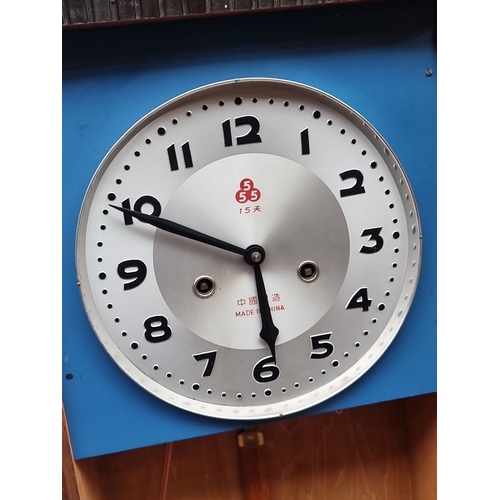 440 - Vintage wooden wall clock with decorative carvings, circular dial, and visible pendulum.