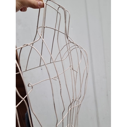 441 - Set of four white wire dress forms with an elegant and minimalist design.