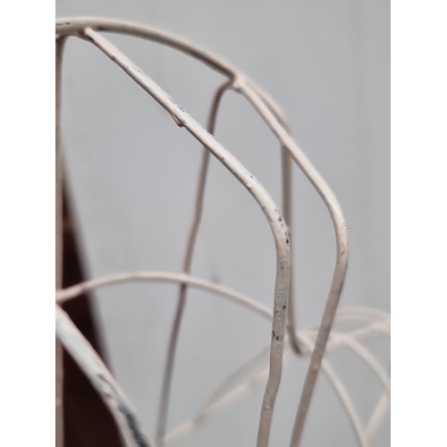 441 - Set of four white wire dress forms with an elegant and minimalist design.