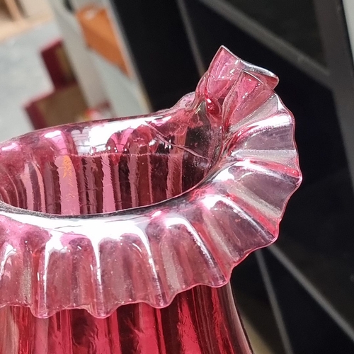 455 - Ruby red glassware set featuring a pitcher, lidded decanter, small bowl, and apple-shaped ornament. ... 