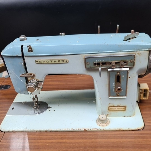 481 - Vintage Brother sewing machine with integrated wooden cabinet and two storage drawers. The machine f... 