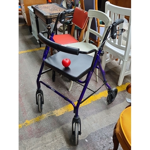 489 - Purple aluminum rollator walker with padded seat, four wheels, and ergonomic hand grips.