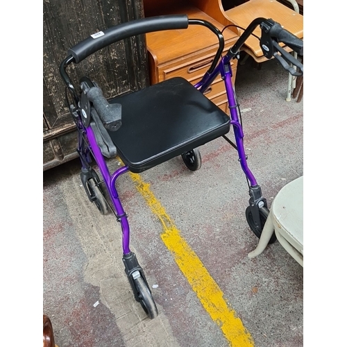 489 - Purple aluminum rollator walker with padded seat, four wheels, and ergonomic hand grips.