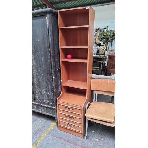 499 - A mid century modern Tall, slim wooden bookcase with three drawers at the base and multiple open she... 