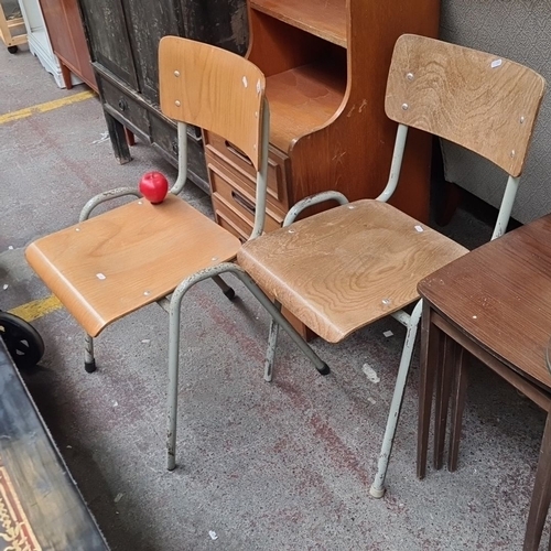 500 - Pair of vintage wooden school chairs with metal frames. Features a light wood finish and robust cons... 