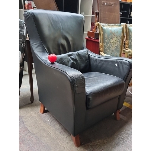 483 - Star Lot : A very high quality Black leather armchair by Italian furniture company Nicoletti, featur... 