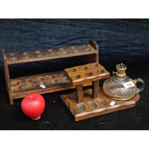 125 - An early 20th century wooden pipe rack with oil lamp, and an apothecary test tube rack.