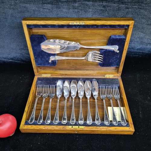 186 - A wooden fish knife and fork canteen set comprising of silver plate cutlery. Comes with original key... 