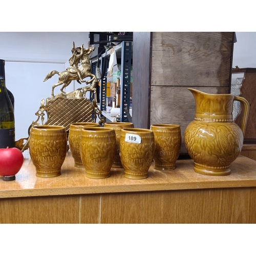 189 - A fantastic Cuba made stoneware pitcher jug accompanied by six matching drinking cups. Marked 