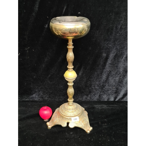 192 - A vintage onyx and brass floor standing ashtray.