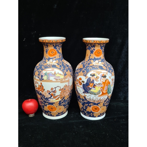 195 - A superb pair of Chinese hand painted raised vases in vibrant tones of blue, red and purple.