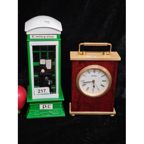 217 - Two items including a snow globe in the form of a old Irish telephone box and a Acctim branded mantl... 