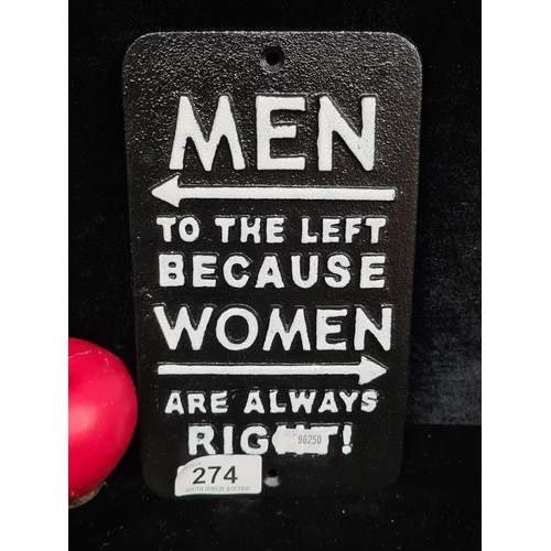 274 - A humorous cast metal wall plaque reading 'Men to the left because Women are always right.'