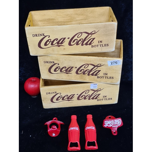 276 - Three vintage style wooden crates advertising Coca Cola, along with four Coca Cola bottle openers in... 