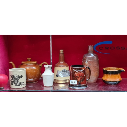 303 - A collection of seven pottery and stoneware items. including scotch whiskey decanter, antique whiske... 