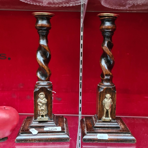 308 - A pair of Charles Dickens related candlesticks with a barley twist and brass detailing. Features Bra... 