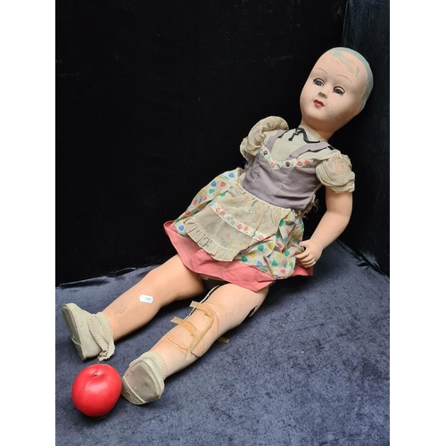 309 - A large antique 'Athena Piacenza' doll with moving eyes and in original clothes. Slight damage, miss... 