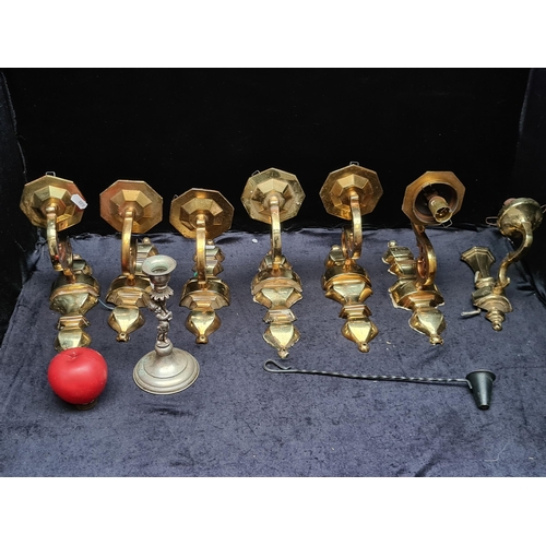 313 - Seven vintage brass wall scones, a cherub candlestick and a snuffer.