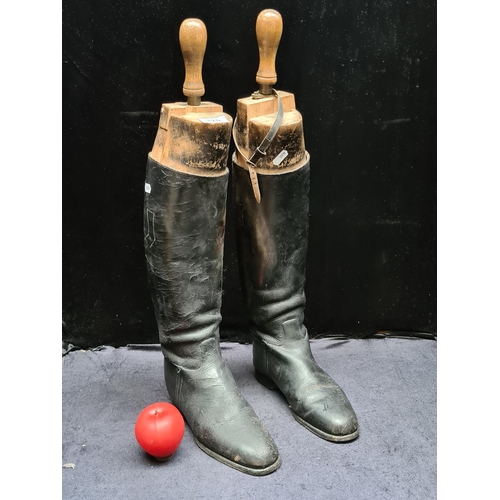 320 - A pair of antique riding boots. Complete with wooden boot trees.