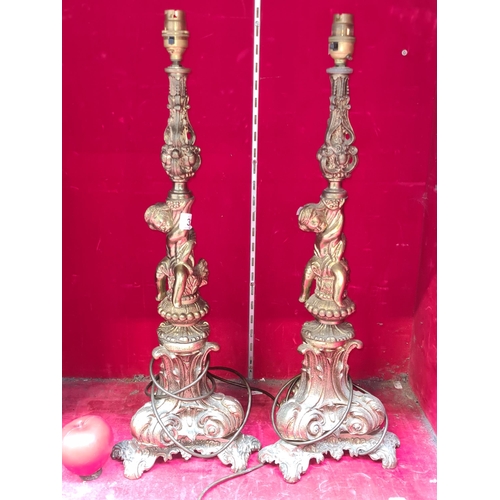 321 - A pair of vintage very tall Solid brass table lamps. Features cherubs and grapes.