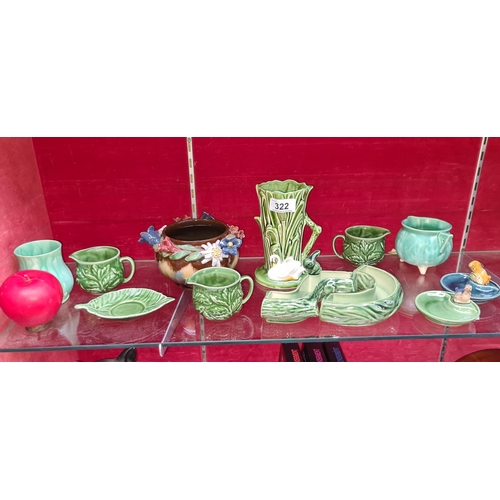 322 - A collection of twelve vintage ceramic items. Including Sylvac, Carrigware and Wade.