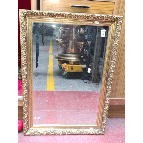 333 - A handsome beveled glass mirror. Housed in a decorative glit frame. Can be hung as portrait or in la... 