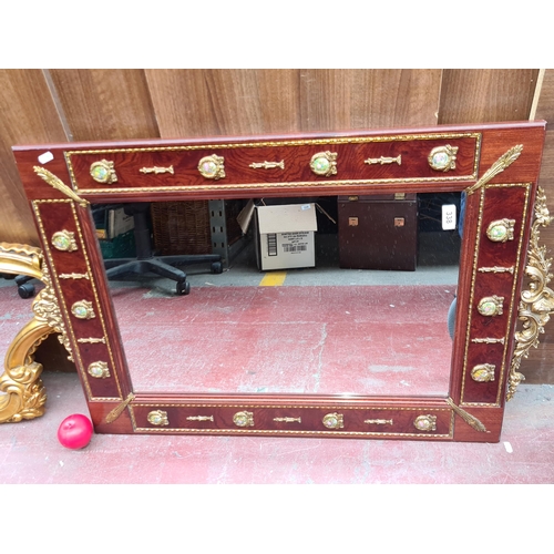 338 - Star Lot : A large antique style mirror with brass toned detailing with printed narrative panels. Ho... 