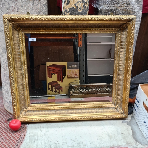 341 - A large thick framed antique style mirror with beveled glass. Housed in a gilt frame. From the Conco... 