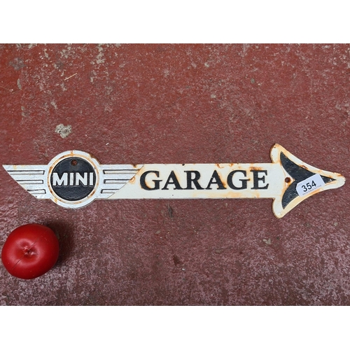 354 - A heavy cast metal finger pointer sign for Mini Garage.