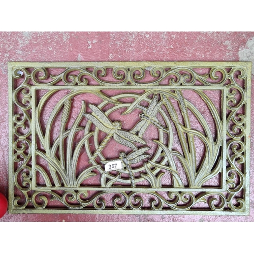 357 - An art Nouveau style  heavy cast metal pierced doormat with dragon fly design.