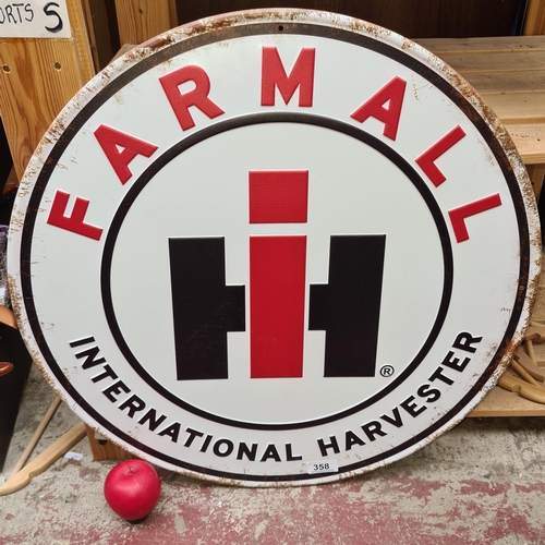 358 - A large circular metal advertising sign for Farmall International Harvester.