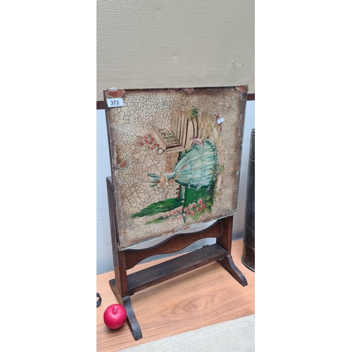 373 - An antique flip top table with a painted scene behind glass. Can be used as a fire screen.