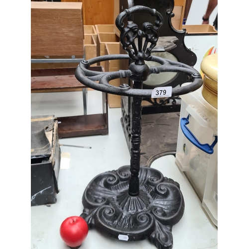 379 - A decorative heavy cast metal umbrella stand.