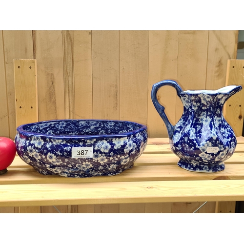 387 - A Victoriaware blue and white ironstone washbasin and jug.