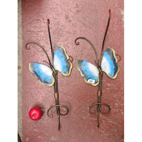 388 - Two metal garden wall mounted hooks with butterfly design.