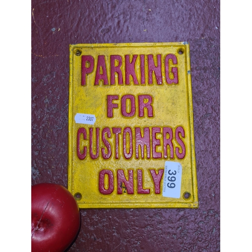 399 - A heavy cast iron wall sign reading 'Parking for Customers Only'