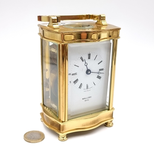 18 - A heavy Mallory Bath brass carriage clock with roman numeral dial. Comes with original key.