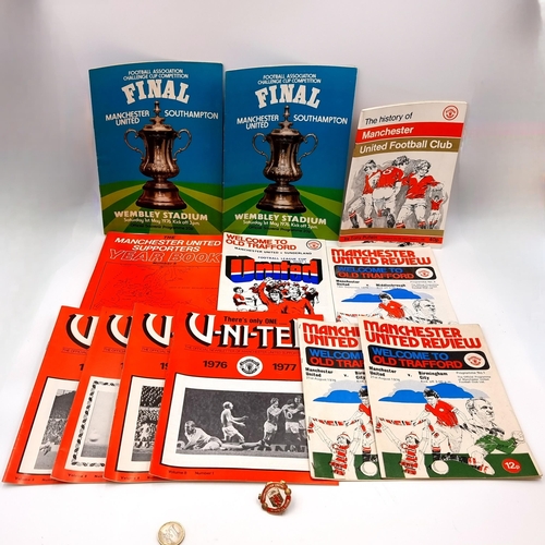 28 - A collection of Manchester United Football Club memorabilia including a pin badge, newsletters, offi... 