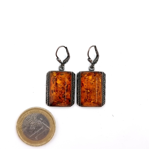 48 - A pair of unusual fire amber drop earrings - suitable for pierced ears.