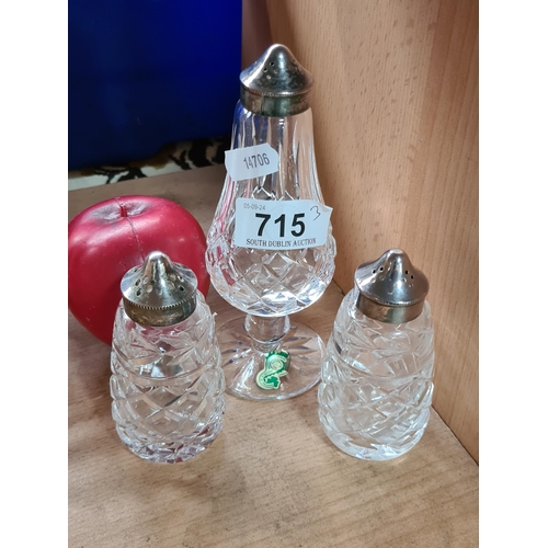 715 - Three Waterford Crystal items including a pair of salt and pepper shakers and an additional salt sha... 