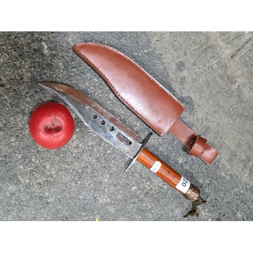 720 - A hunting knife with wooden handle and original leather sheath.