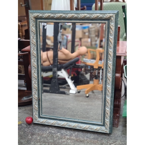 751 - A heavy good quality large mirror with molded gilt and green frame and bevelled glass.