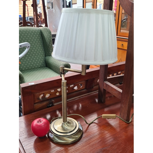 752 - A brushed brass articulated table lamp with pleated shade.