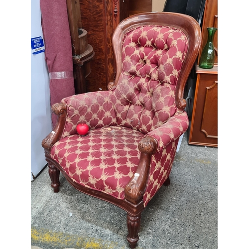 758 - A 19th century style carved mahogany framed armchair with button back.