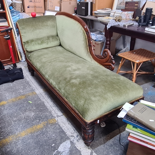 796 - A fabulous Victorian chaise lounge with carved wooden frame and moss green upholstery.