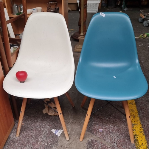 649 - Pair of Mid-Century Modern style plastic shell chairs with wooden legs. One chair is white, and the ... 