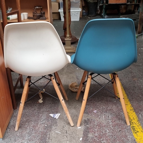 649 - Pair of Mid-Century Modern style plastic shell chairs with wooden legs. One chair is white, and the ... 